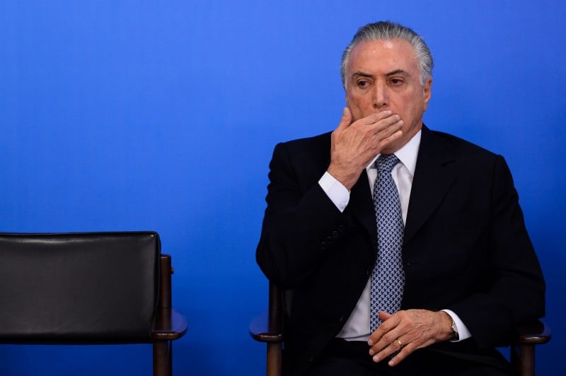 Brazilian acting President Michel Temer gestures as he speaks next to Finance Minister Henrique Meirelles (out of frame) during a meeting with business leaders at Planalto Palace in Brasilia, June 8, 2016.  Brazil's annual inflation rate crept up last month to 9.32 percent, officials said Wednesday, sounding new alarm bells for Latin America's largest economy as it struggles through a deep recession. The stubbornly high inflation rate had been looking somewhat better recently, falling in each of the past three months, to 9.28 percent in April. / AFP PHOTO / ANDRESSA ANHOLETE  