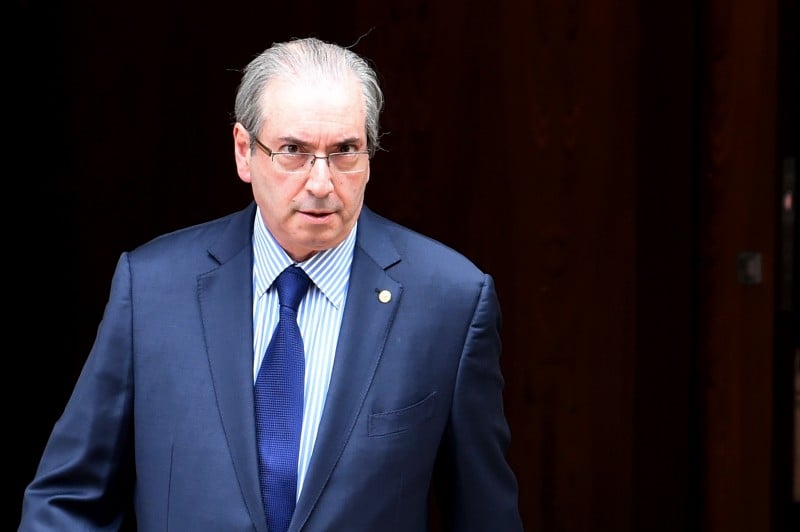  The president of the Brazilian chamber of deputies, Eduardo Cunha leaves the official residence on his way to the Congress in Brasilia on December 17, 2015. The Attorney General of the Republic, Rodrigo Janot, presented to the Federal Supreme Court (STF) a request for precautionary removal of Eduardo Cunha from the position of Congressman and Speaker of the House.  AFP PHOTO/EVARISTO SA  