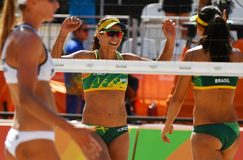 Brazil's Larissa Franca Maestrini (L) celebrates with her teammate Talita Rocha during the women's beach volleyball qualifying match between Brazil and Russia at the Beach Volley Arena in Rio de Janeiro on August 7, 2016, for the Rio 2016 Olympic Games. 