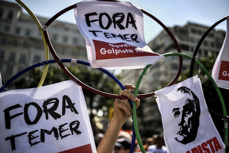 People demonstrate against the Rio 2016 Olympic Games and the interim President Michel Temer in Rio de Janeiro on August 5, 2016. Thousands of Brazilians launched angry anti-Olympics protests hours before Friday's Rio Games opening ceremony in fury at political scandals rattling the host country and the billions spent on the event. Waving signs reading 