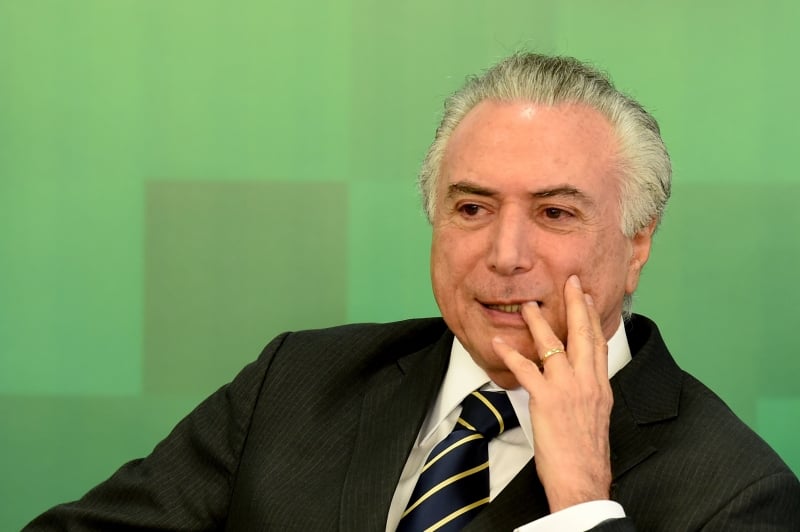  Brazil's acting President Michel Temer attends the ceremony to announce the increase of the Bolsa Familia (Income Distribution Program) and the release of funds for education at the Planalto Palace in Brasilia on June 29, 2016. The government announced an average increase of 12.5% in the Bolsa Familia program, following two years without adjustment. / AFP PHOTO / EVARISTO SA  