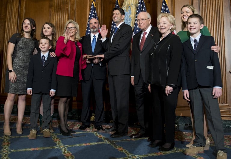 Former US Vice President Dick Cheney (4th R) poses with US Congressman Paul Ryan (C), R-Wisconsin, as his daughter, US Congresswoman Liz Cheney (4th L) is sworn in during the opening of the 115th US Congress on Capitol Hill in Washington, DC, January 3, 2017. / AFP PHOTO / JIM WATSON
      Caption