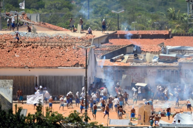 Inmates are seen during confrontation between gangs at the vandalised facilities of the Alcacuz Penitentiary Center near Natal in Rio Grande do Norte, Brazil on January 19, 2017.
Stick-wielding inmates hurled stones and lit fires Thursday in a Brazilian jail where dozens were previously massacred, as authorities struggled to contain a spreading wave of gang violence.
 / AFP PHOTO / ANDRESSA ANHOLETE Alcaçuz