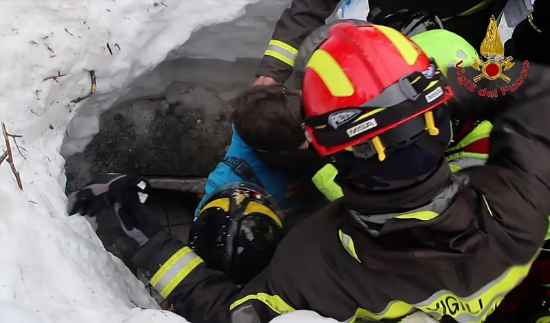 A handout picture released on January 20, 2017 by the Vigili del Fuoco shows a child (C) being rescued from the Hotel Rigopiano, near the village of Farindola, on the eastern lower slopes of the Gran Sasso mountain, engulfed by a powerful avalanche a day before.
Up to 30 people were feared to have died after an Italian mountain Hotel Rigopiano was engulfed by a powerful avalanche in the earthquake-ravaged centre of the country. Italy's Civil Protection agency confirmed the Hotel Rigopiano had been engulfed by a two-metre (six-feet) high wall of snow and that emergency services were struggling to get ambulances and diggers to the site.