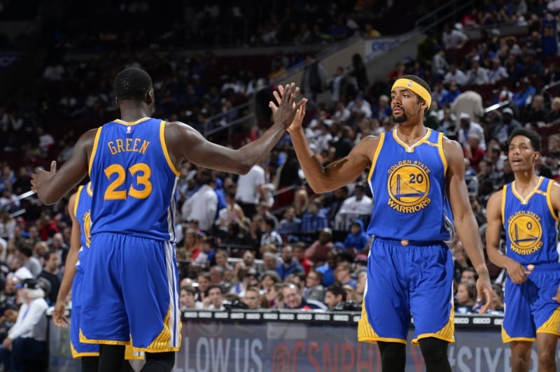 PHILADELPHIA, PA - FEBRUARY 27: Draymond Green #23 and James Michael McAdoo #20 of the Golden State Warriors high-five during a game against the Philadelphia 76ers on February 27, 2017 at the Wells Fargo Center in Philadelphia, Pennsylvania. NOTE TO USER: User expressly acknowledges and agrees that, by downloading and/or using this photograph, user is consenting to the terms and conditions of the Getty Images License Agreement. Mandatory Copyright Notice: Copyright 2017 NBAE   David Dow/NBAE via Getty Images/AFP
      Caption