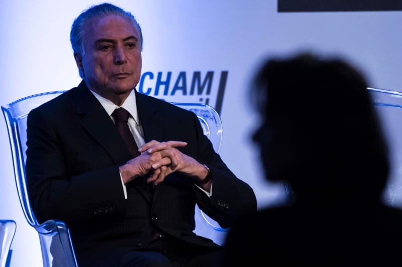 Brazilian President Michel Temer gestures during a lunch meeting with businessmen at the American Chamber of Commerce, in Sao Paulo, Brazil, on March 20,  2017.
Temer is facing the serious mission of calming a scandal threatening the reputation of the world's biggest beef and poultry exporting nation, after police reported on March 17 that a two-year probe found major meat producers had bribed health inspectors to certify tainted food as fit for consumption. Brazilian meat is exported to more than 150 countries, with principal markets as far apart as Saudi Arabia, China, Singapore, Japan, Russia, the Netherlands and Italy.
 / AFP PHOTO / NELSON ALMEIDA
      Caption