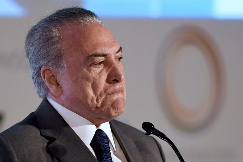Brazilian President Michel Temer delivers a speech during the opening session of the Conference of Latin American Cities, in Brasilia, on March 21, 2017.
During his speech Temer referred to Brazil's rotten meat scandal which involves allegations that major meatpacking businesses bribed inspectors to get health certificates and masked tainted meat as fit for consumption. The fallout from the scandal accelerated Monday when China, a huge client, suspended imports and the European Union demanded a partial ban. / AFP PHOTO / EVARISTO SA
      Caption