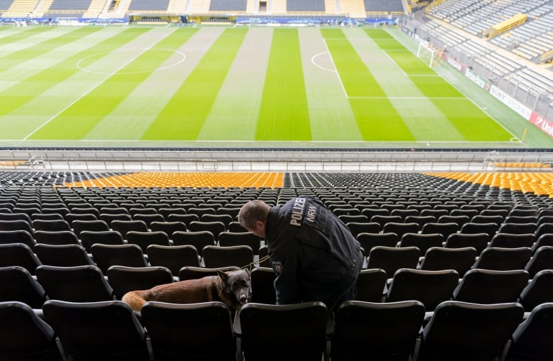 A policeman and an explosive detection sniffer dog do their work at the stadium in Dortmund, western Germany, on April 12, 2017, as security measures are under way prior to the UEFA Champions League quarter-final, first-leg football match of German first division Bundesliga club Borussia Dortmund vs Monaco.
The match, that originally was set to take place on April 11, was postponed one day after an attack on Dortmund's team bus. German police investigated a possible Islamist link to three explosions that rocked the Borussia Dortmund football team bus as the club vowed it won't give in to 