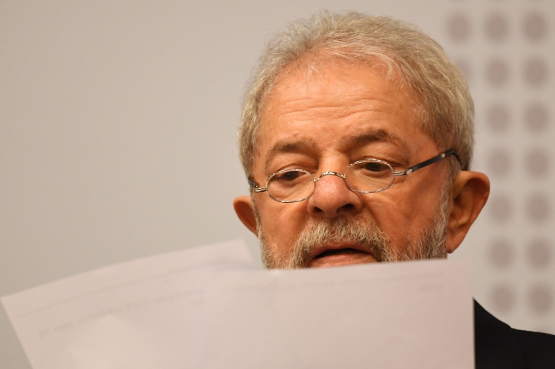 Former Brazilian President (2003-2010) Luiz Inacio Lula da Silva reads during a seminar on 
