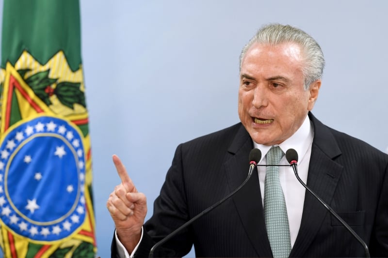 Brazil's President Michel Temer speaks during a press conference following allegations that he gave his blessing to payment of hush money to a politician convicted of corruption, on May 18, 2017 in Brasilia.
Temer faced growing pressure to resign Thursday after the Supreme Court gave its green light to the investigation over allegations that he authorized paying hush money to already jailed Eduardo Cunha, the disgraced former speaker of the lower house of Congress.  / AFP PHOTO / EVARISTO SA
      Caption