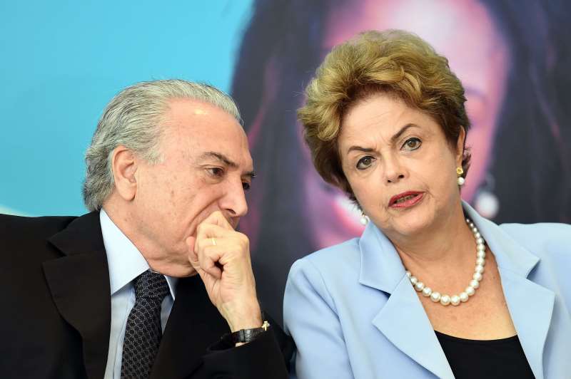 BRAZILIAN PRESIDENT DILMA ROUSSEFF (R) AND VICE-PRESIDENT MICHEL TEMER ATTEND THE LAUNCHING CEREMONY OF THE INVESTMENT PROGRAM IN ENERGY AT PLANALTO PALACE IN BRASILIA, ON AUGUST 11, 2015. ANALYSTS SAY BRAZIL'S ONCE BOOMING ECONOMY SUFFERS DEEP UNDERLYING ILLNESSES, NOTABLY THE MASSIVE CORRUPTION SCANDAL UNFOLDING AT NATIONAL OIL COMPANY PETROBRAS AND RIPPLING ACROSS OTHER TOP COMPANIES AND INTO POLITICAL CIRCLES. IT IS ALSO ON THE BRINK OF RECESSION. ACCORDING TO A RECENT POLL THAT PUT ROUSSEFF'S APPROVAL RATING AT EIGHT PERCENT, SHE IS NOW BRAZIL'S MOST UNPOPULAR DEMOCRATICALLY ELECTED PRESIDENT SINCE A MILITARY DICTATORSHIP ENDED IN 1985.   AFP PHOTO / EVARISTO SA